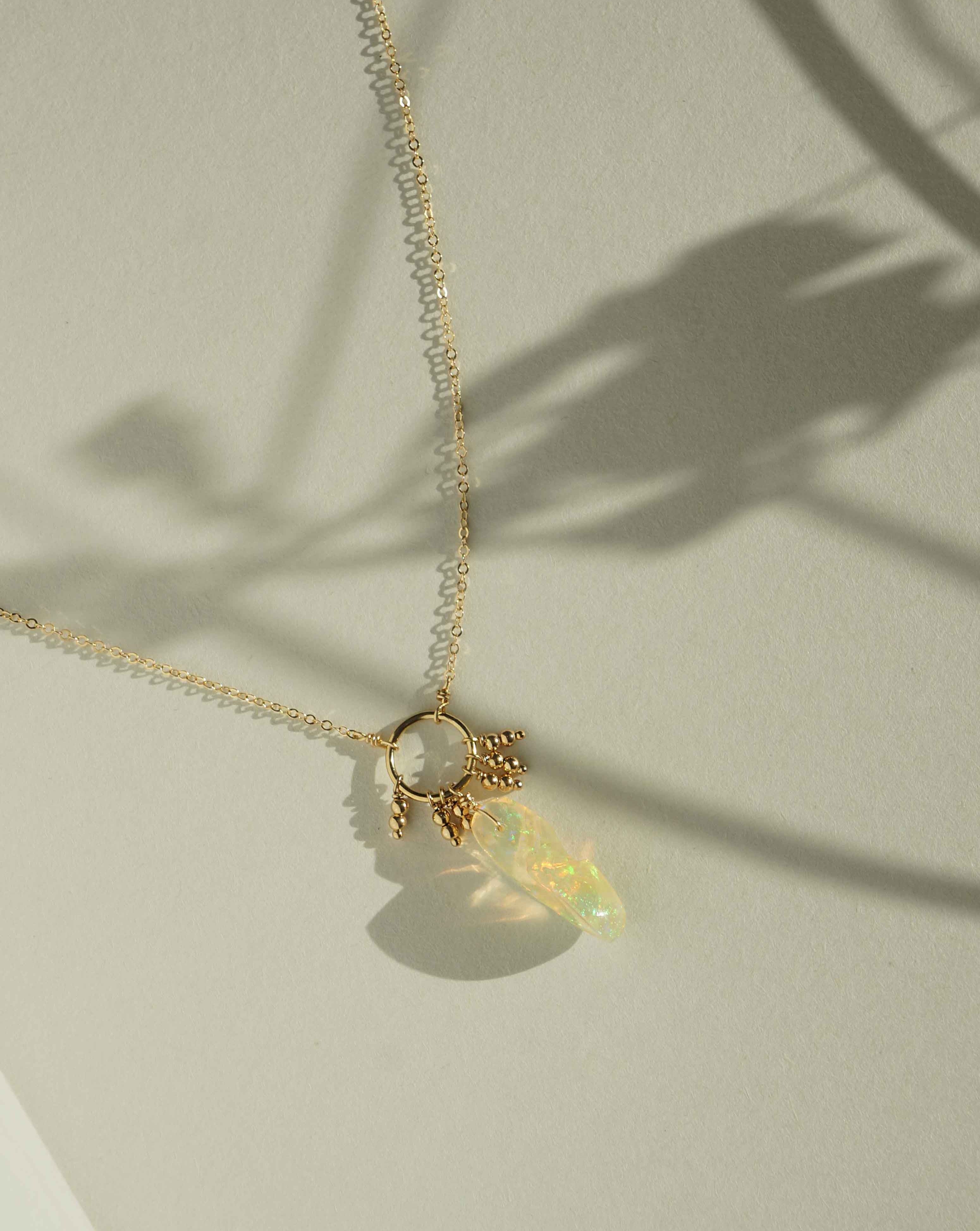 Mella Necklace by KOZAKH. A 16 to 18 inch adjustable length necklace, crafted in 14K Gold Filled, featuring an organic shaped Ethiopian Opal and seamless beads.