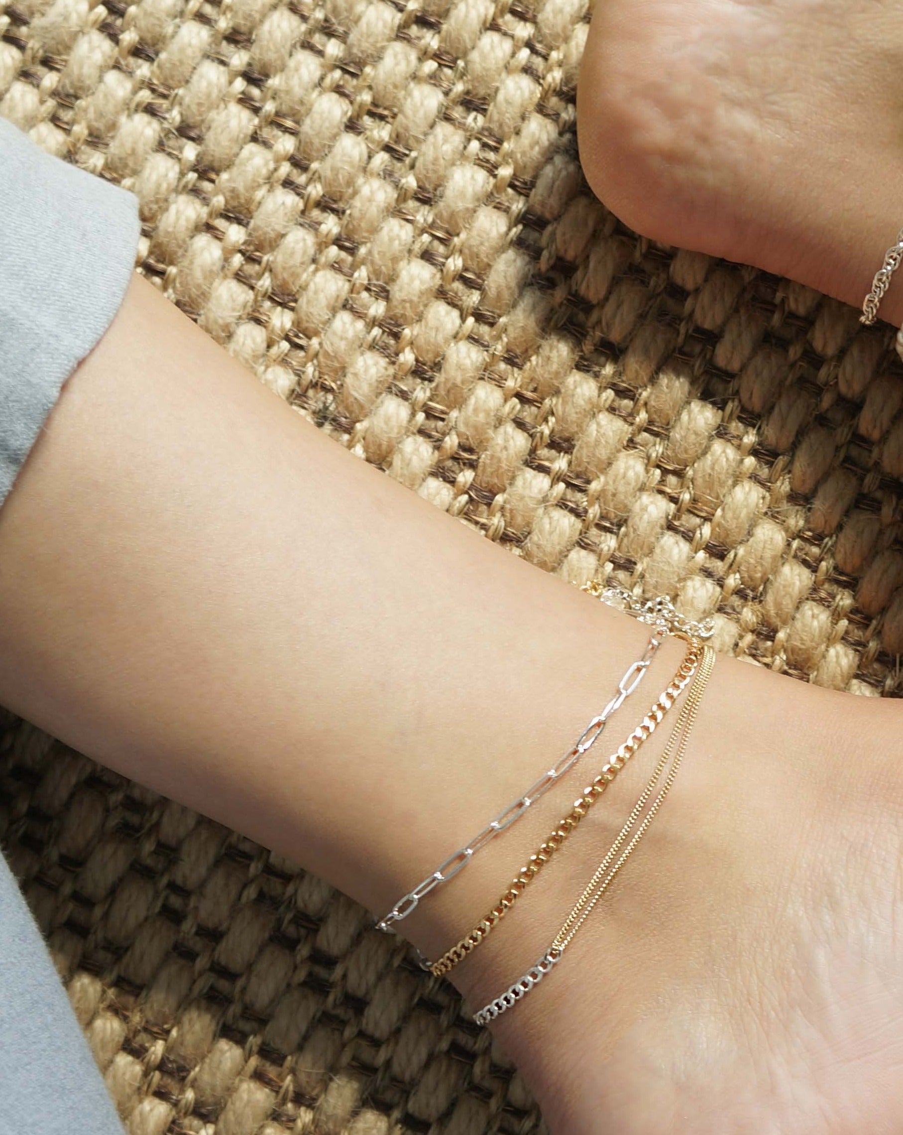 Moni Anklet by KOZAKH. A 9 to 11 inch adjustable length combo anklet with Gold Filled flat link chain on one half and Sterling Silver Cuban link chain on the other half.
