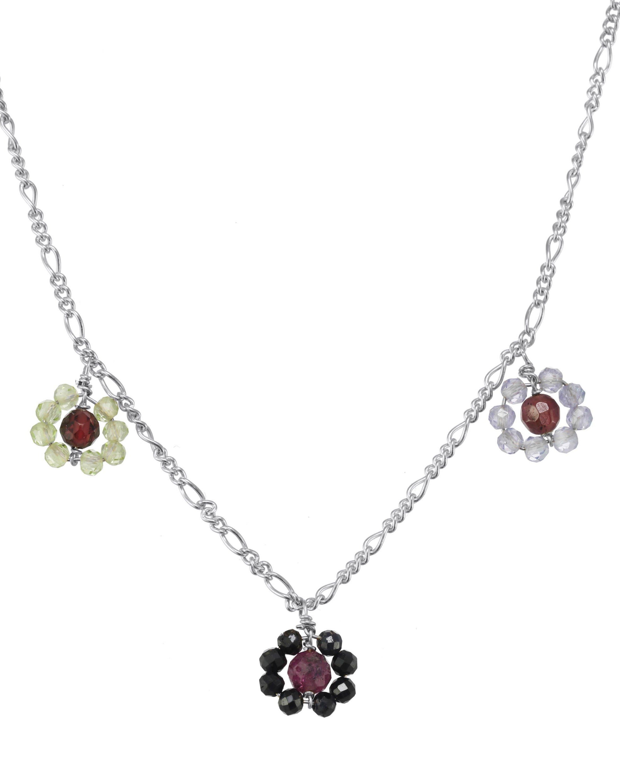 Montanita Necklace by KOZAKH. A 16 to 18 inch adjustable length necklace, crafted in Sterling Silver, featuring 2mm Sapphire, Tanzanite and Peridot and 3mm Ruby and Garnet forming flower charms.