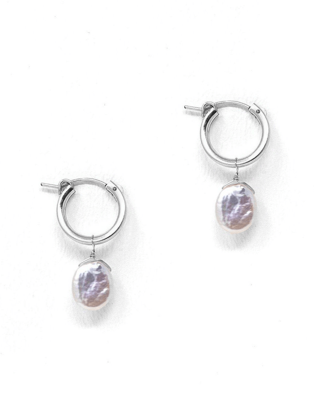 Nancy Hoop Earrings by KOZAKH. 15mm snap closure hoop earrings in Sterling Silver, featuring a 13mm flat oval Pearl.