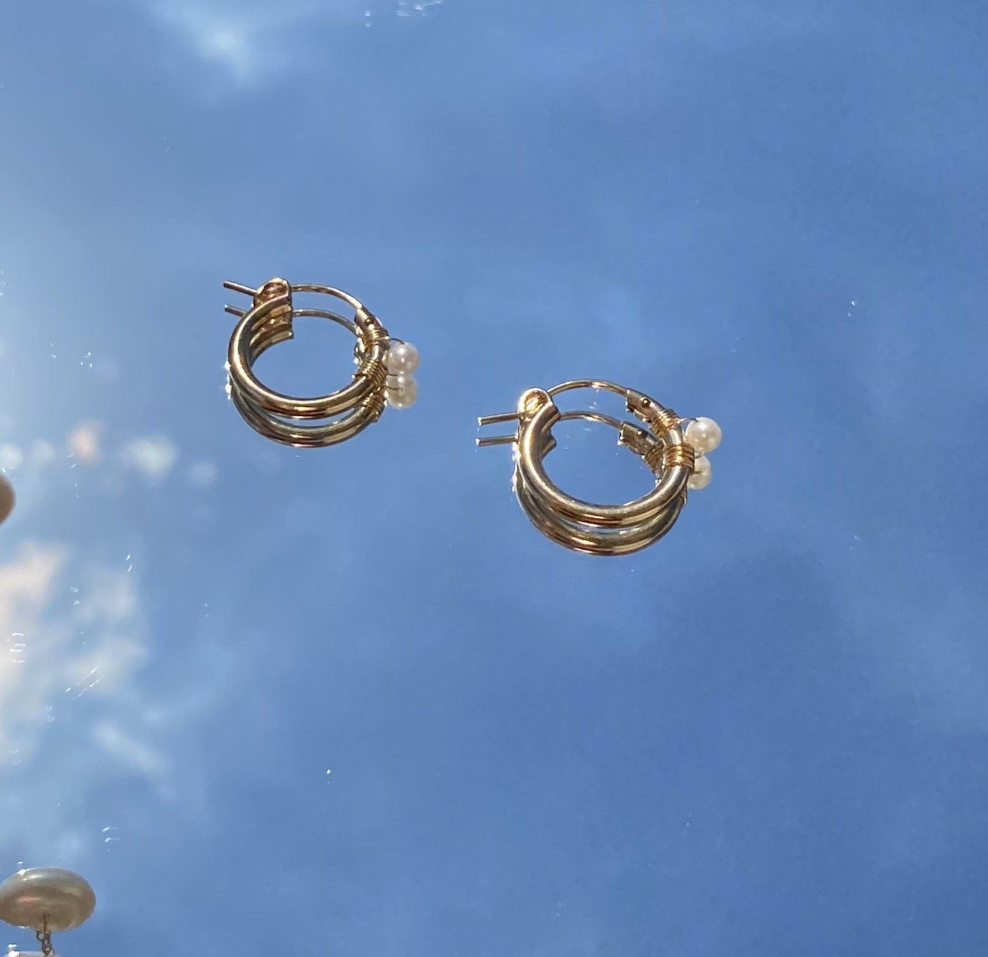 Natalie Earrings by KOZAKH. 12mm snap closure hoop earrings in 14K Gold Filled, featuring a 7mm white potato Pearl.