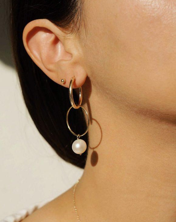 Nova Hoop Earrings by KOZAKH. 22mm snap closure hoop earrings in 14K Gold Filled, featuring an 8-9mm round Pearl.