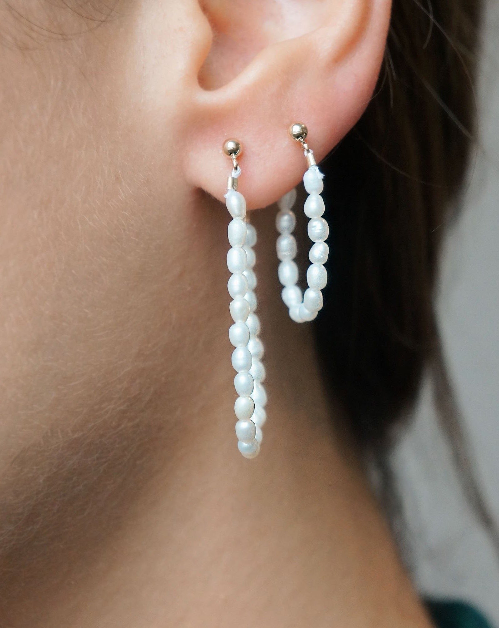 Nube Earring by KOZAKH. 3mm ball earring stud, crafted in 14K Gold Filled, featuring a 1 1/2 inch drop length of 3mm white Rice Pearls.
