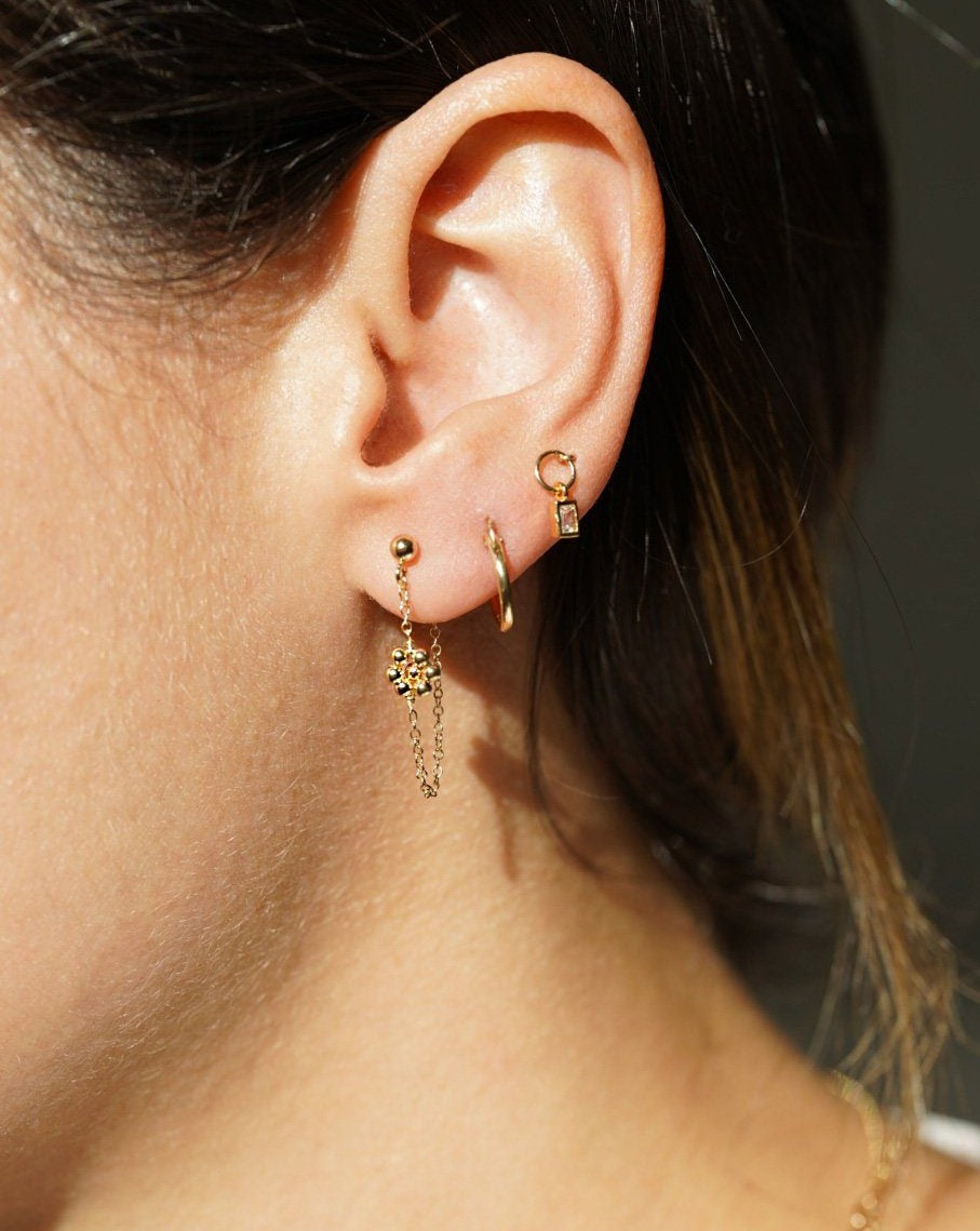Rosana Earrings by KOZAKH. Front/back style stud closure earrings, crafted in 14K Gold Filled, featuring dangling handmade beaded daisy charms.