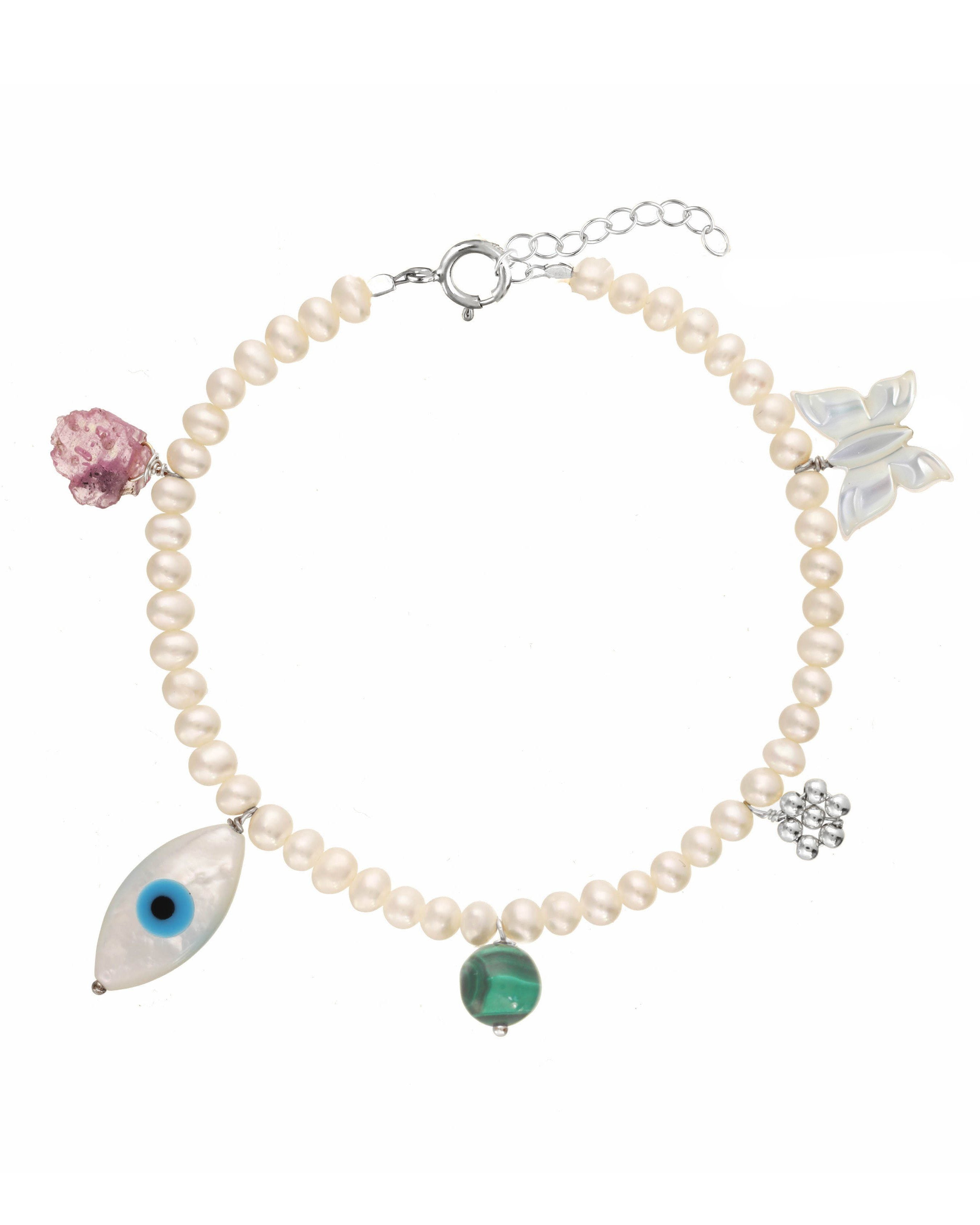 Rylan Bracelet by KOZAKH. A 6 to 7 inch adjustable length, 3mm freshwater pearl strand bracelet, crafted in Sterling Silver, featuring a Pink Tourmaline slice, a Mother of Pearl butterfly charm, a round Malachite gemstone, and Mother of Pearl evil eye charm. 