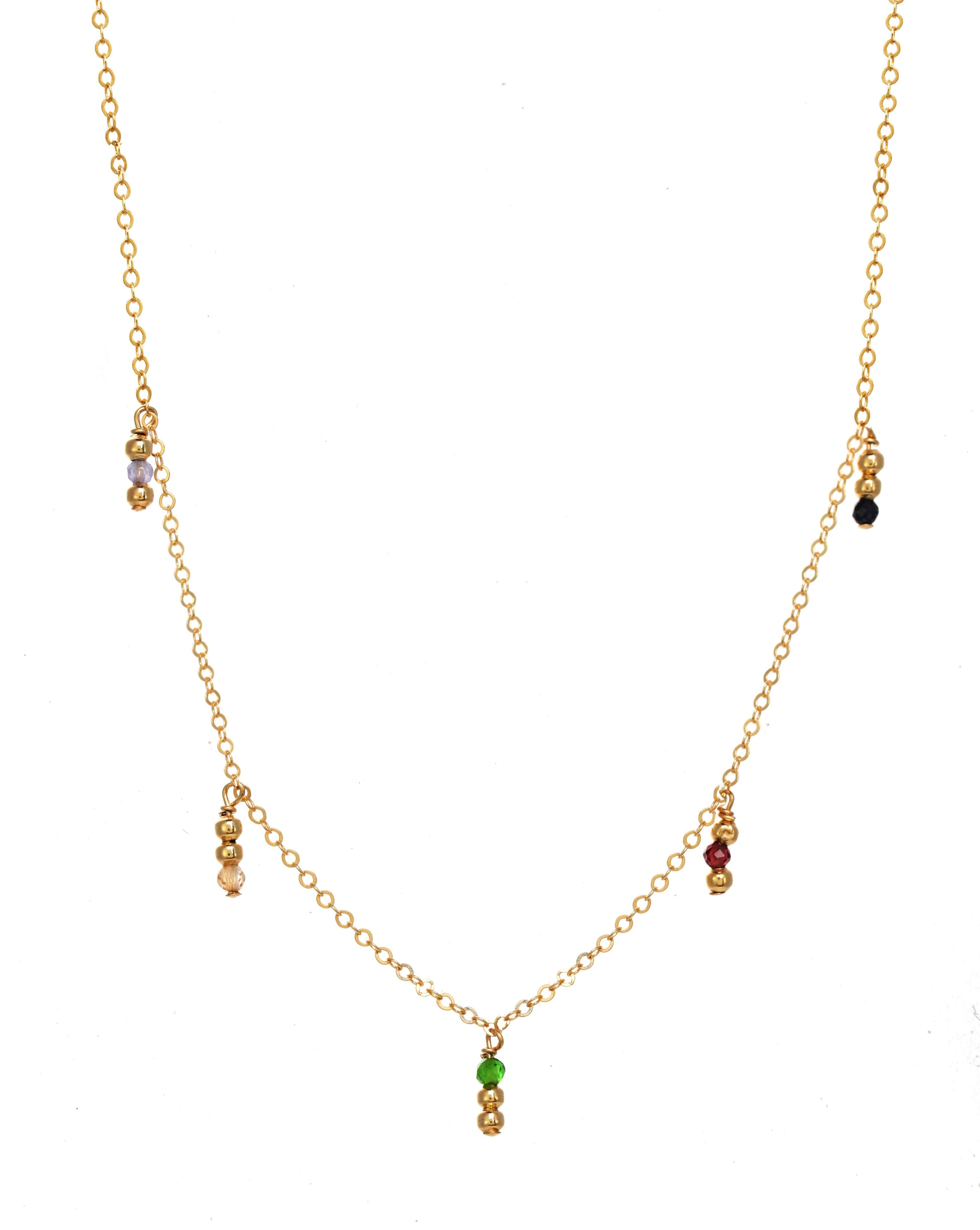Saga Necklace by KOZAKH. A 16 to 18 inch adjustable length necklace, crafted in 14K Gold Filled, featuring 2mm Seamless round beads and 2mm Faceted round Emerald, Garnet, Sapphire, Tanzanite and Topaz.