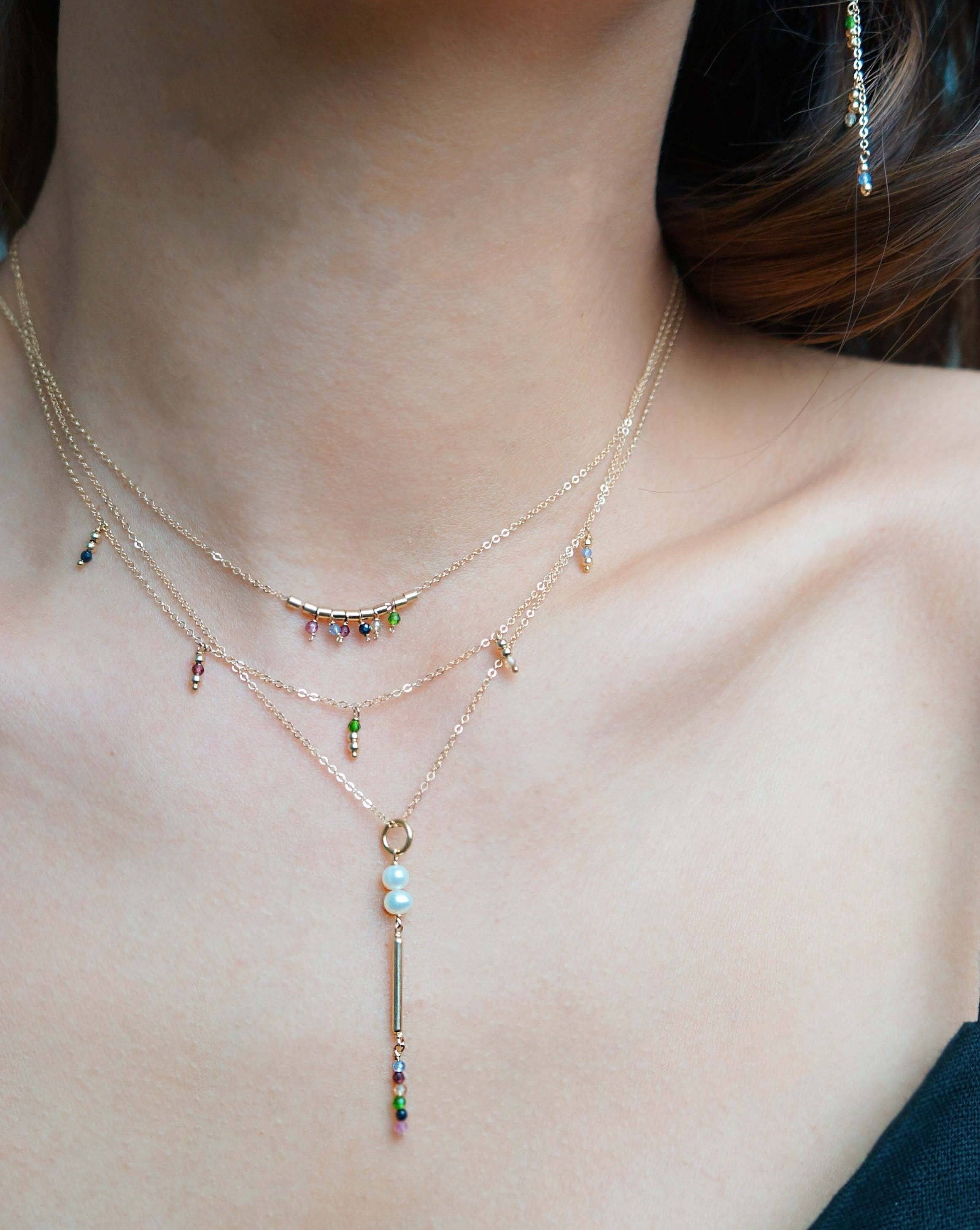 Salma Necklace by KOZAKH. A 16 to 18 inch adjustable length necklace, crafted in 14K Gold Filled, featuring 2mm Faceted round Emerald, Garnet, Sapphire, Tourmaline, Tanzanite and Topaz.