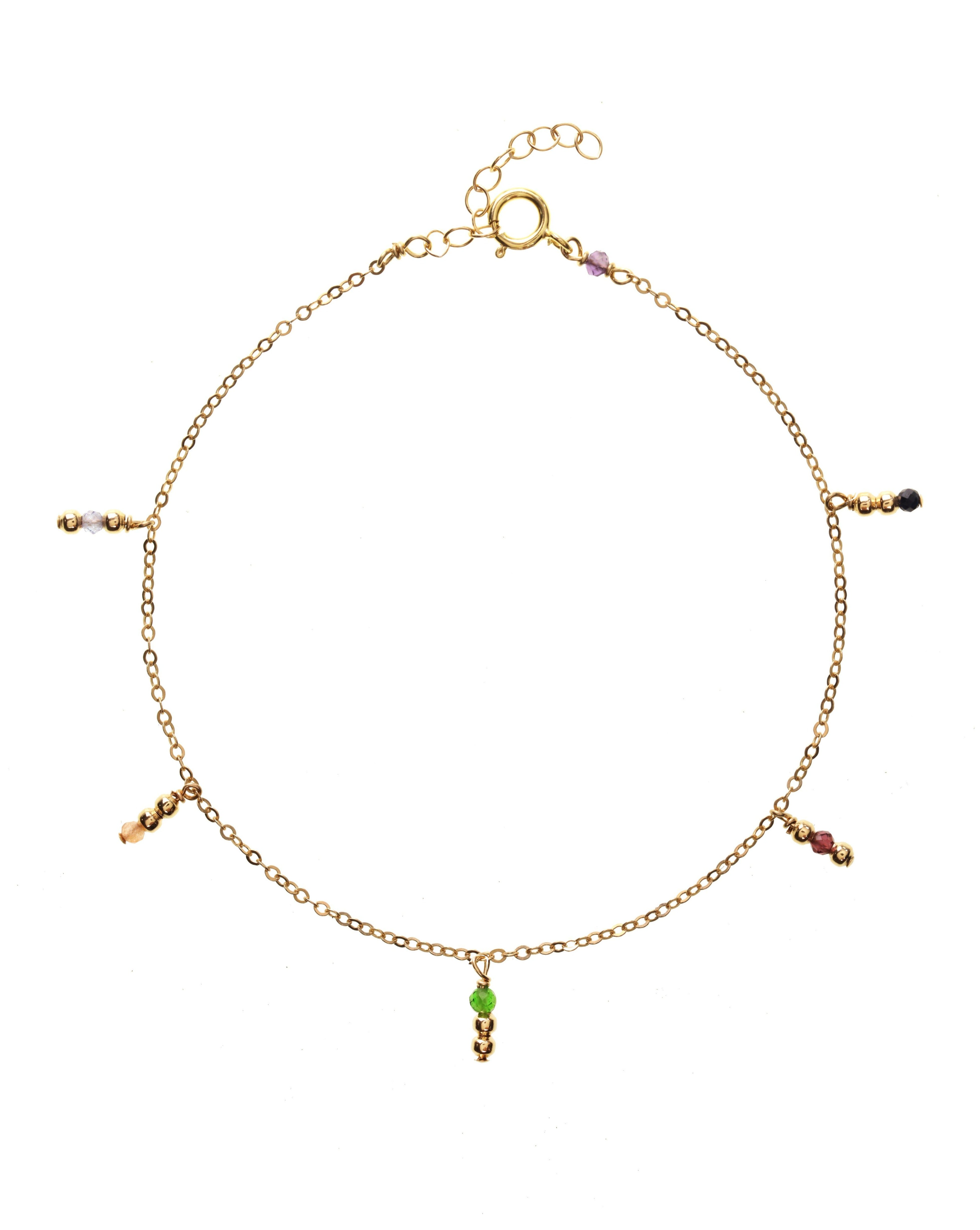 Sami Bracelet by KOZAKH. A 6 to 7 inch adjustable length bracelet, crafted in 14K Gold Filled, featuring 2mm Seamless gold beads and faceted 2mm Aquamarine, Garnet, Imperial Topaz, Emerald, Sapphire and Tanzanite. 