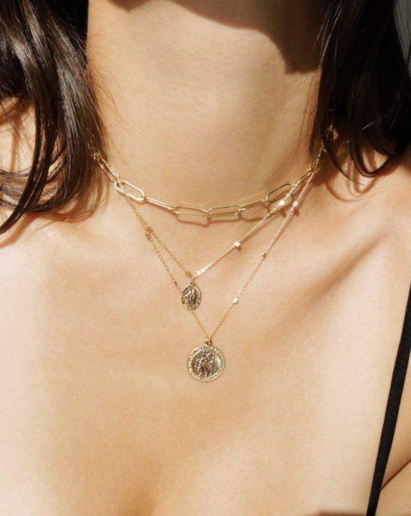San Cris Oval Necklace by KOZAKH. A 16 to 18 inch adjustable length necklace, crafted in 14K Gold Filled, featuring a 16mm Saint Christopher oval Medallion.