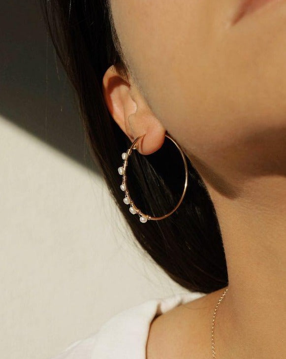 Sea Hoop Earrings by KOZAKH. 40mm hoop earrings in 14K Gold Filled, featuring 3mm to 4mm Rice white pearls.