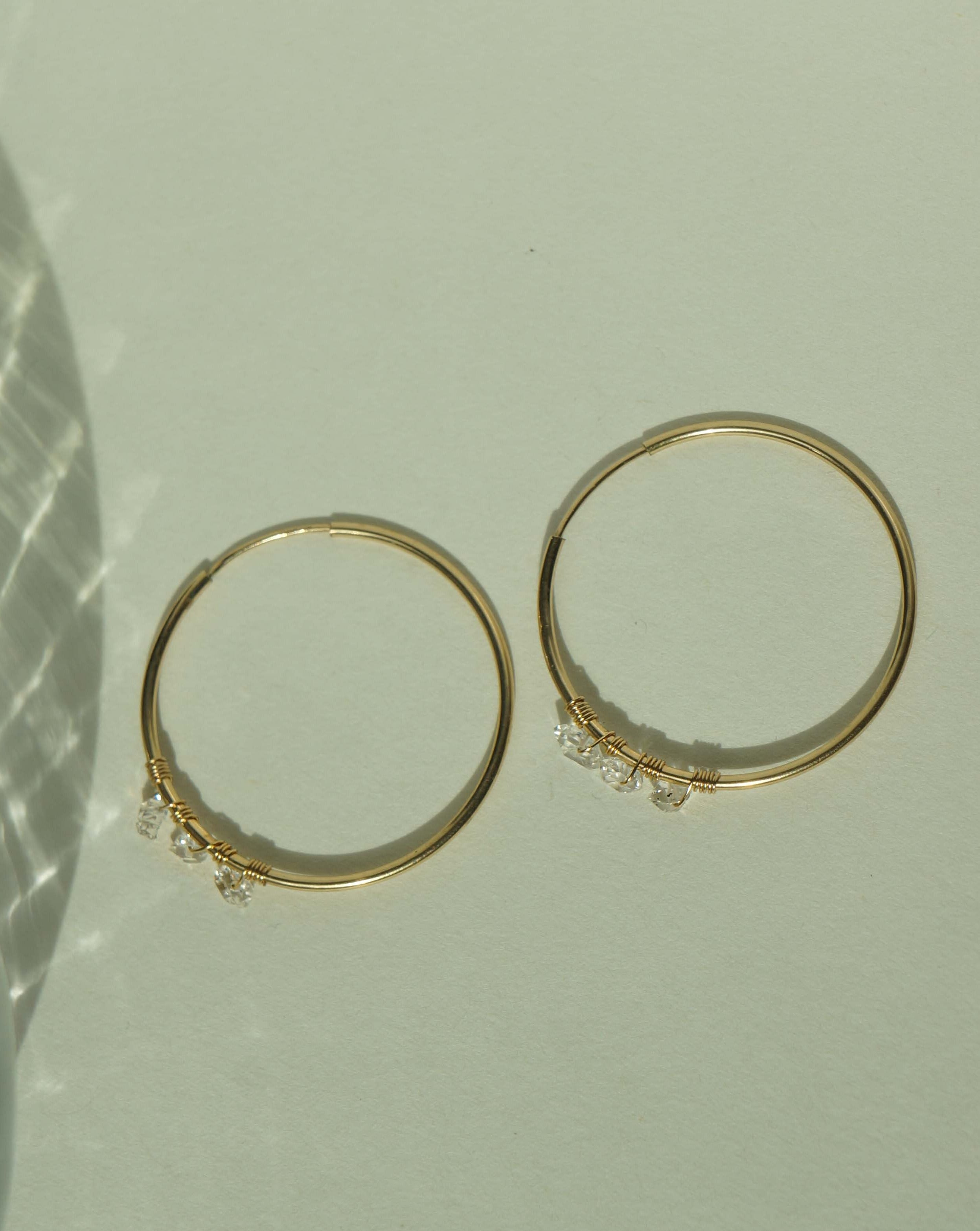 Selena Herkimer Hoop Earrings by KOZAKH. 30mm hoop earrings in 14K Gold Filled, featuring Herkimer Diamonds.
