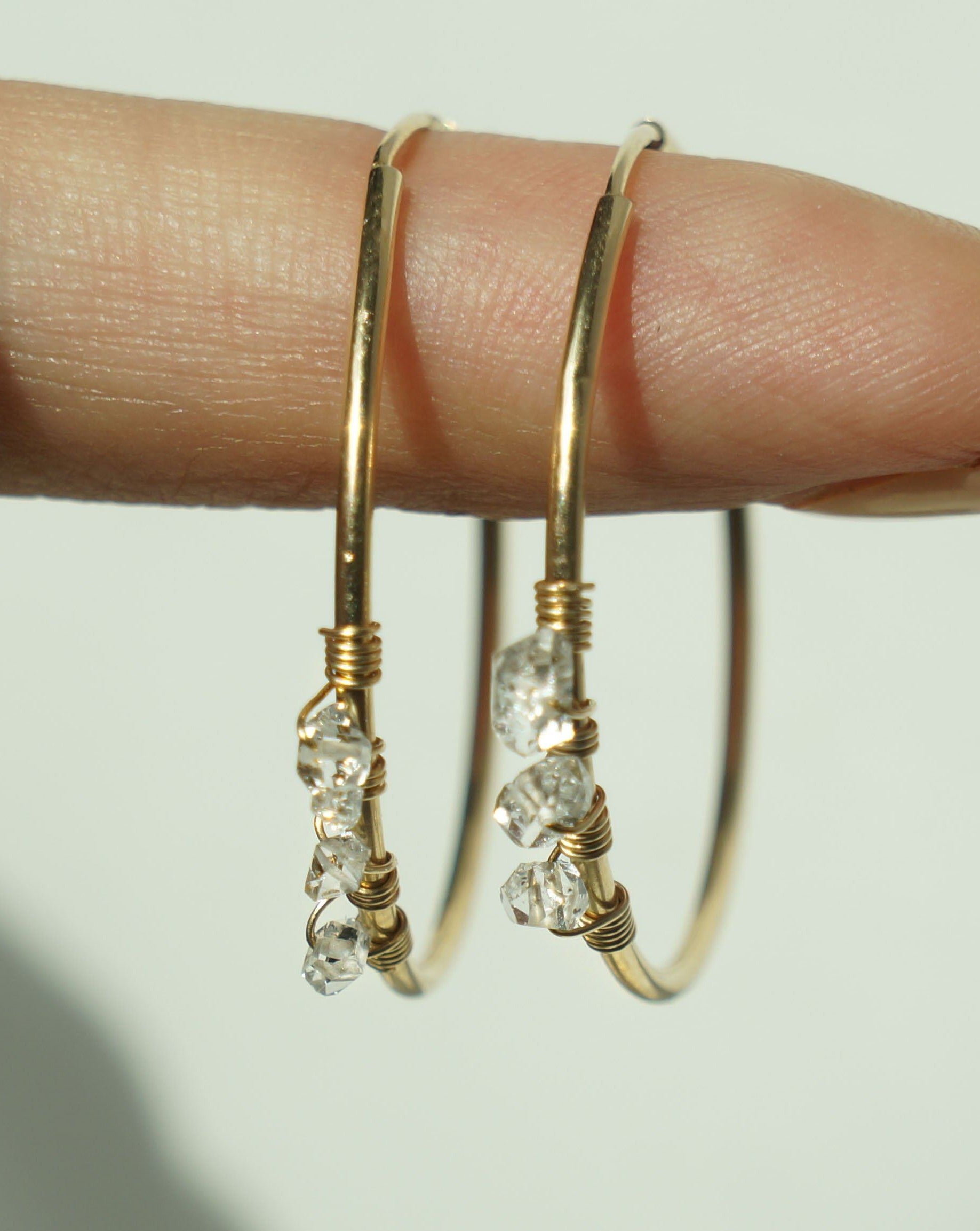Selena Herkimer Hoop Earrings by KOZAKH. 30mm hoop earrings in 14K Gold Filled, featuring Herkimer Diamonds.