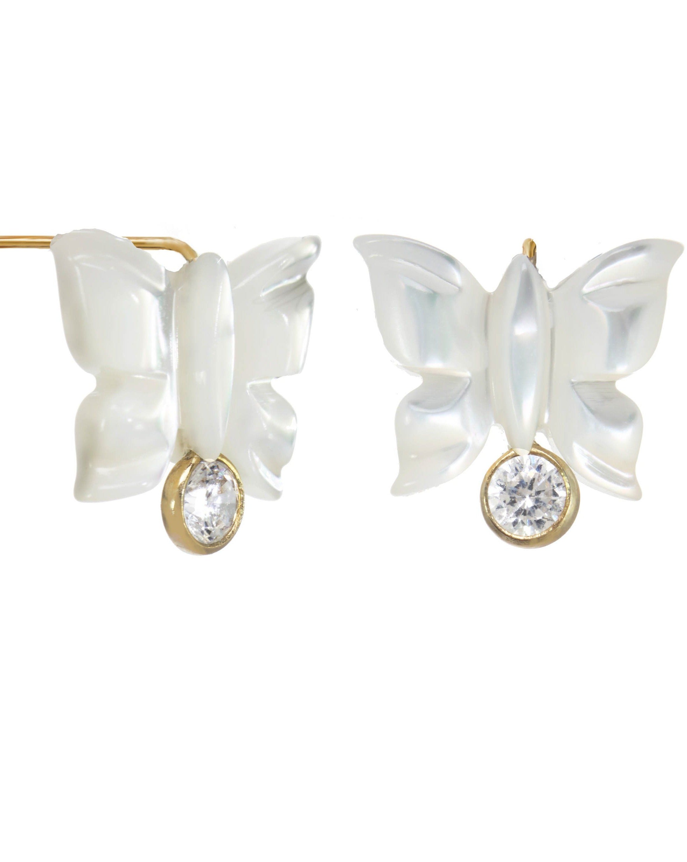 Sevyn Earrings by KOZAKH. Stud earrings, crafted in 14K Gold Filled, featuring a hand carved butterfly charm and a bezel set Cubic Zirconia.