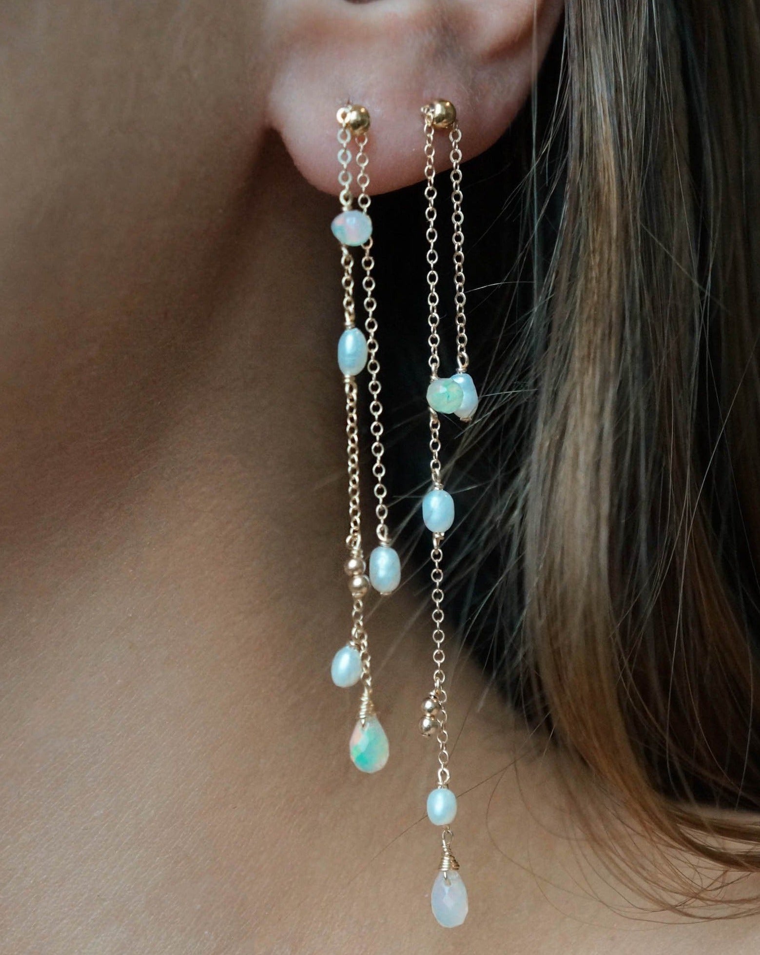 Shasta Earrings by KOZAKH. 1 3/4 inches long dangling earrings, crafted in 14K Gold Filled, featuring 3-4mm White rice beads and 5-6mm Faceted Ethiopian Opal droplets.