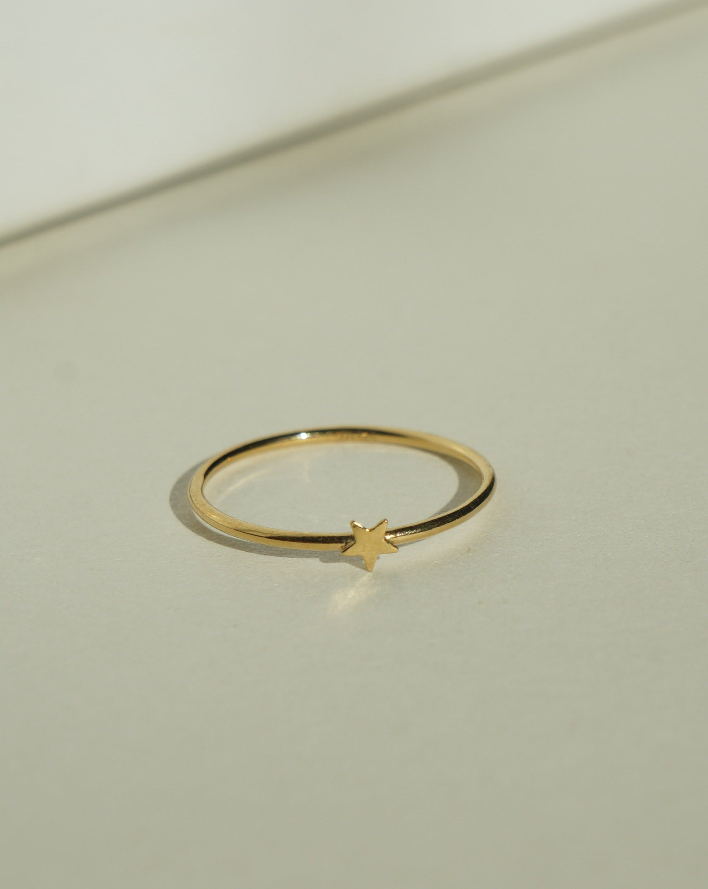 Star Ring by KOZAKH. A 1mm band, crafted in 14K Gold Filled, featuring a star shape design.