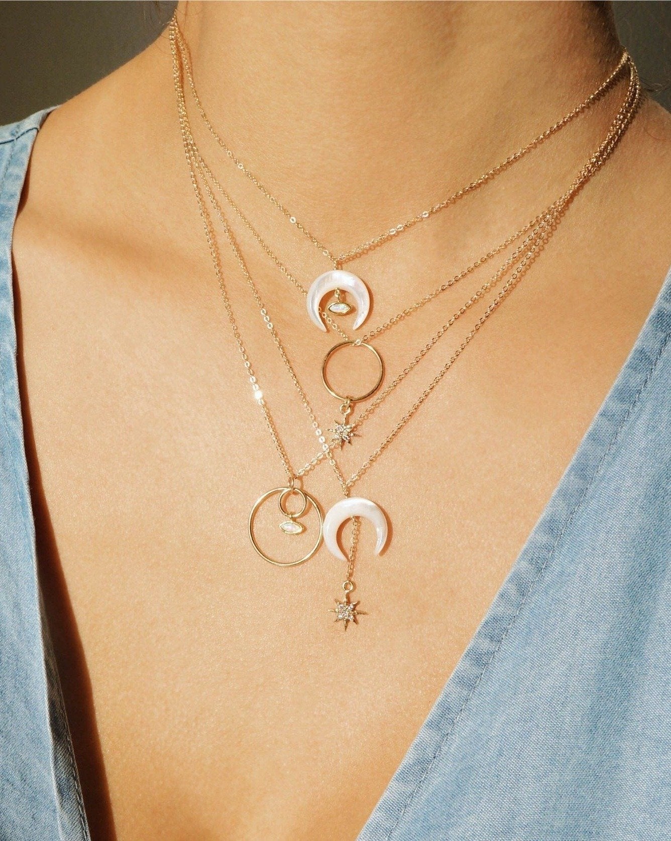 Stella Necklace by KOZAKH. A 16 to 18 inch adjustable length necklace, crafted in 14K Gold Filled, featuring a hand carved Mother of Pearl crescent moon charm and a Cubic Zirconia encrusted 6 point star.