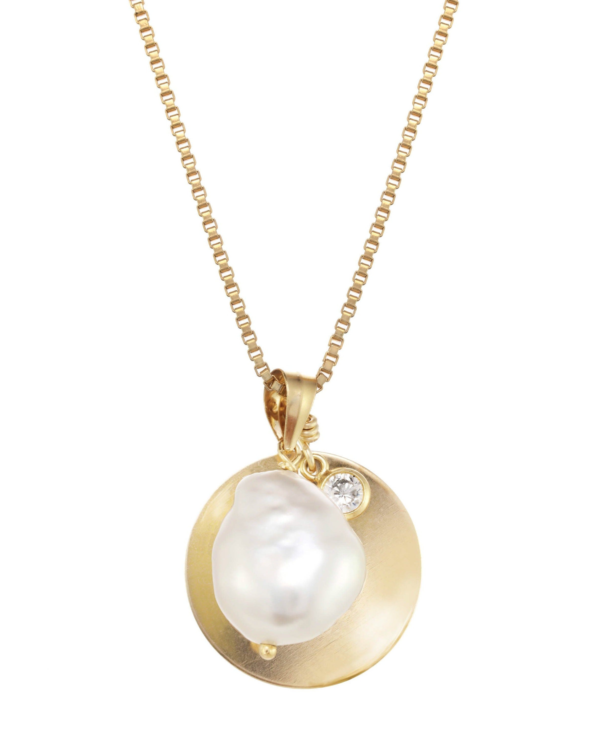 Sylet Necklace by KOZAKH. A 16 to 18 inch adjustable length necklace, crafted in 14K Gold Filled, featuring a 9mm Oval pearl, a 16mm Coin medallion, and a 3mm Cubic Zirconia bezel.