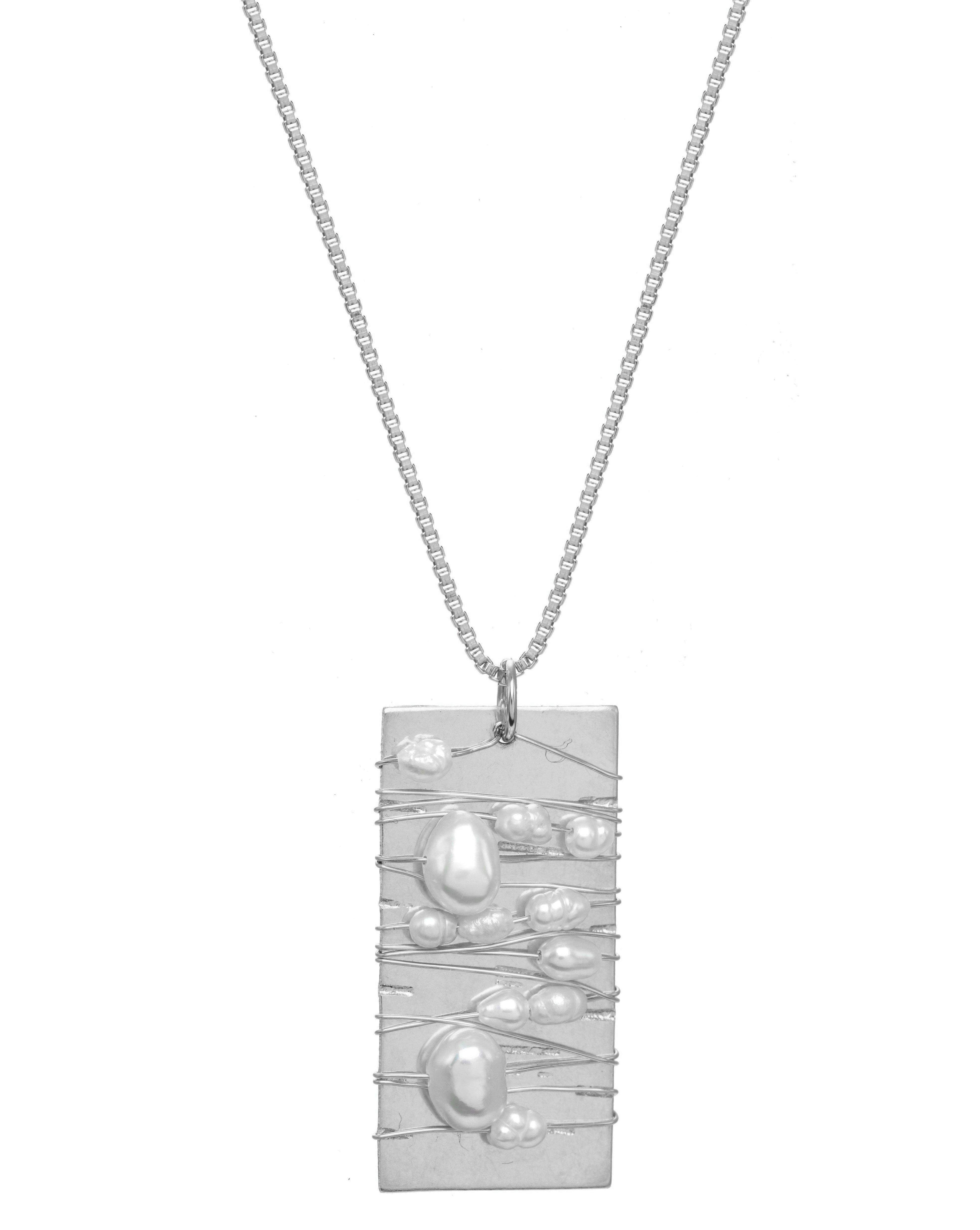 Tabla Necklace by KOZAKH. A 20 inches long necklace, crafted in Sterling Silver, featuring a 14x28mm flat rectangle medallion wrapped with white rice pearls and irregular white Pearls.