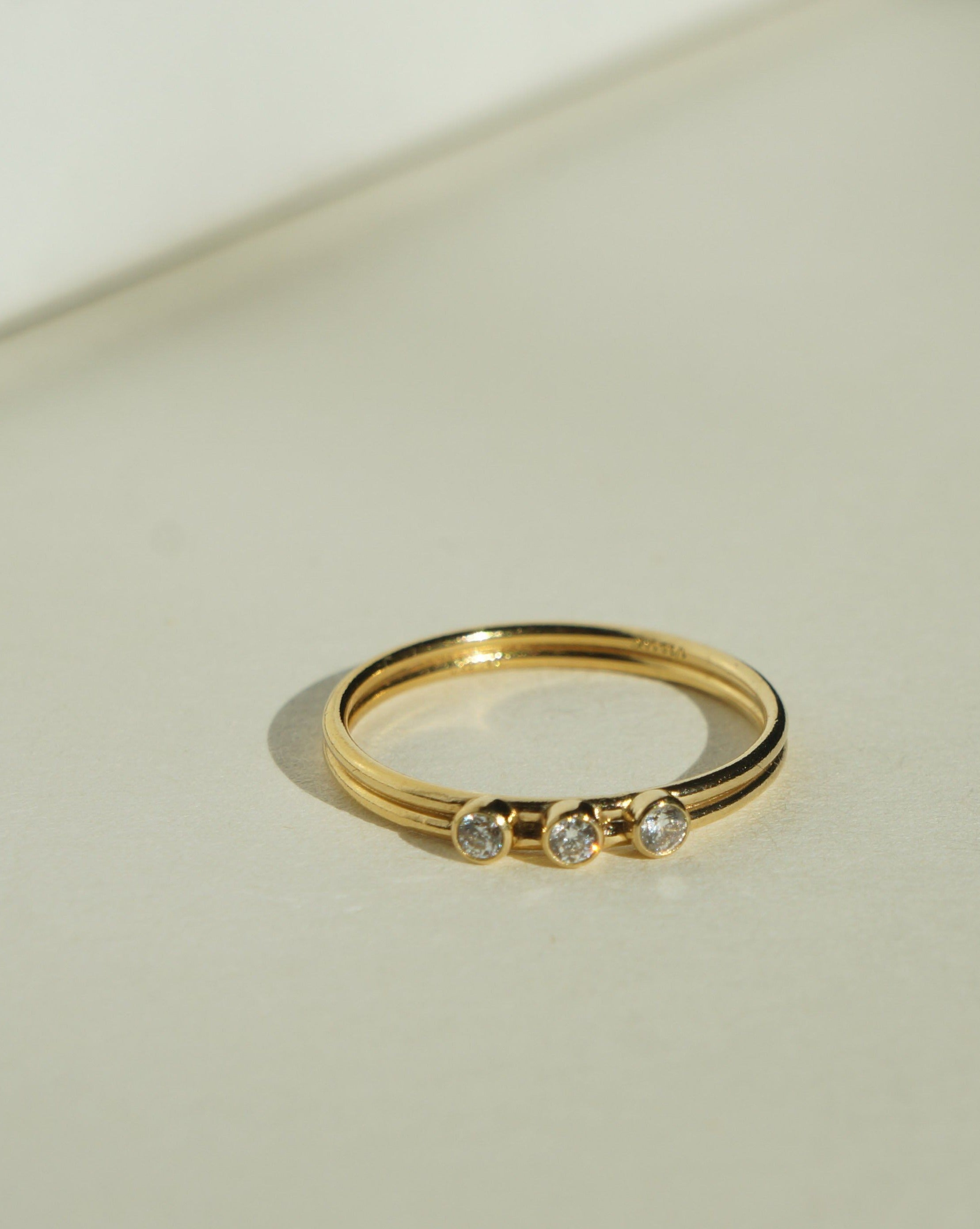 Tres Dia Ring by KOZAKH. A 1mm double band, crafted in 14K Gold Filled, featuring three 2mm Cubic Zirconias.