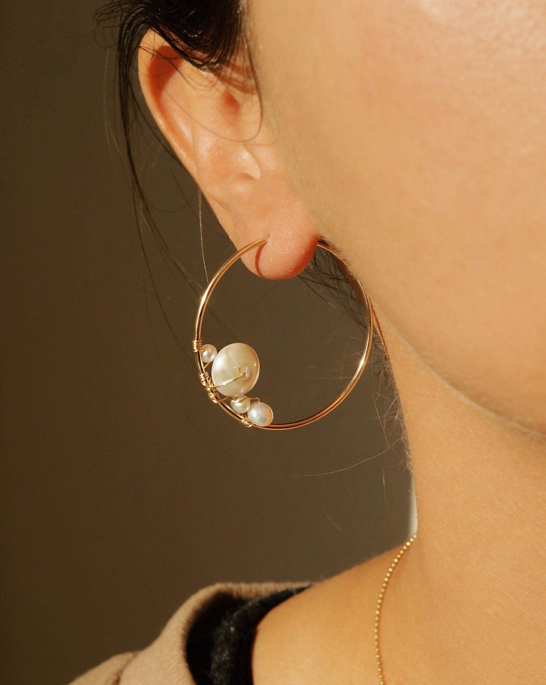 Tulum Hoop Earrings by KOZAKH. 38mm hoop earrings, crafted in 14K Gold Filled, featuring White Keshi pearl, 5mm White potato pearl, and 6mm Irregular shaped white pearl.