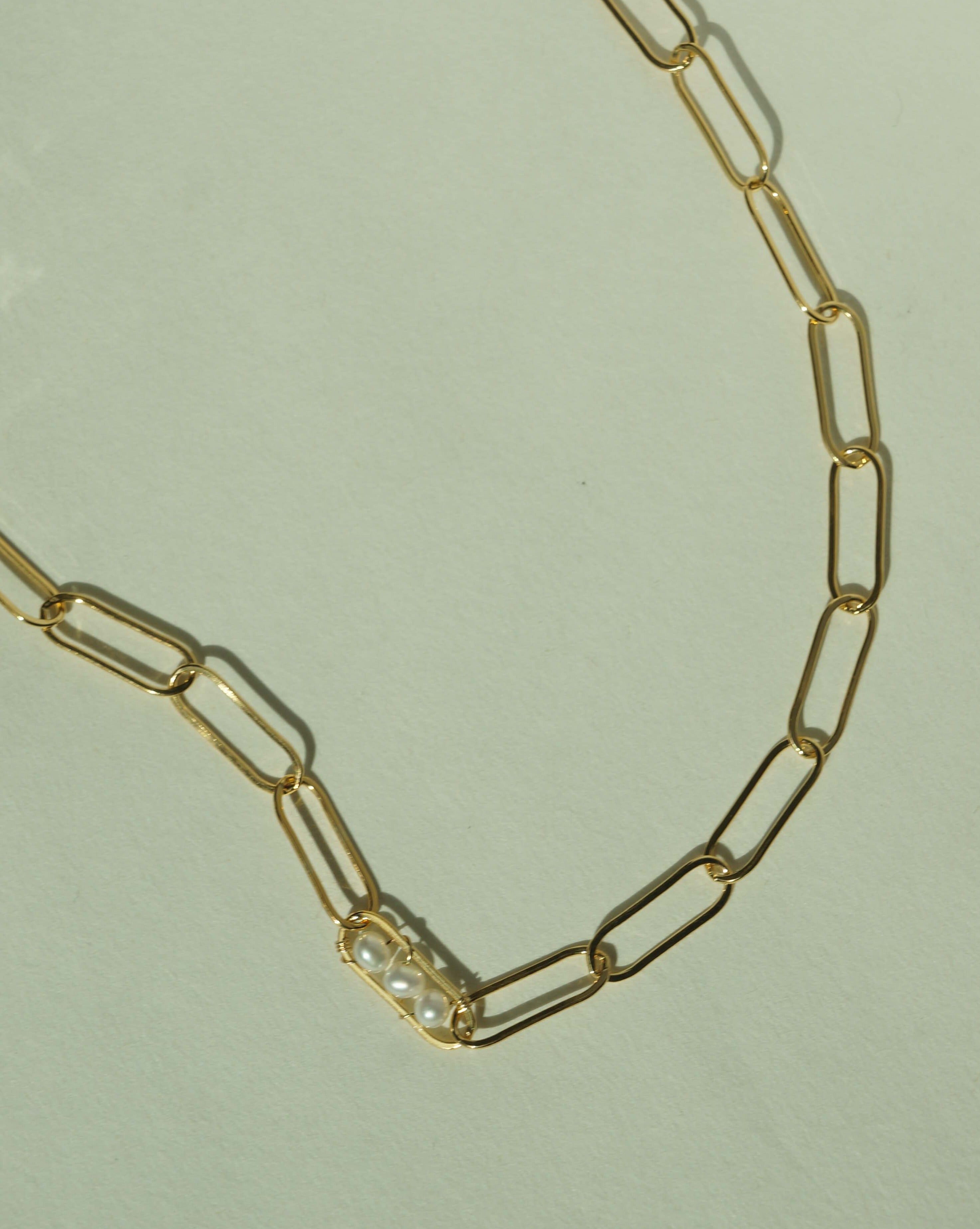Vanessa Necklace by KOZAKH. A 14 to 16 inch adjustable length, flat link chain necklace, crafted in 14K Gold Filled, featuring 3mm to 4mm white pearls.