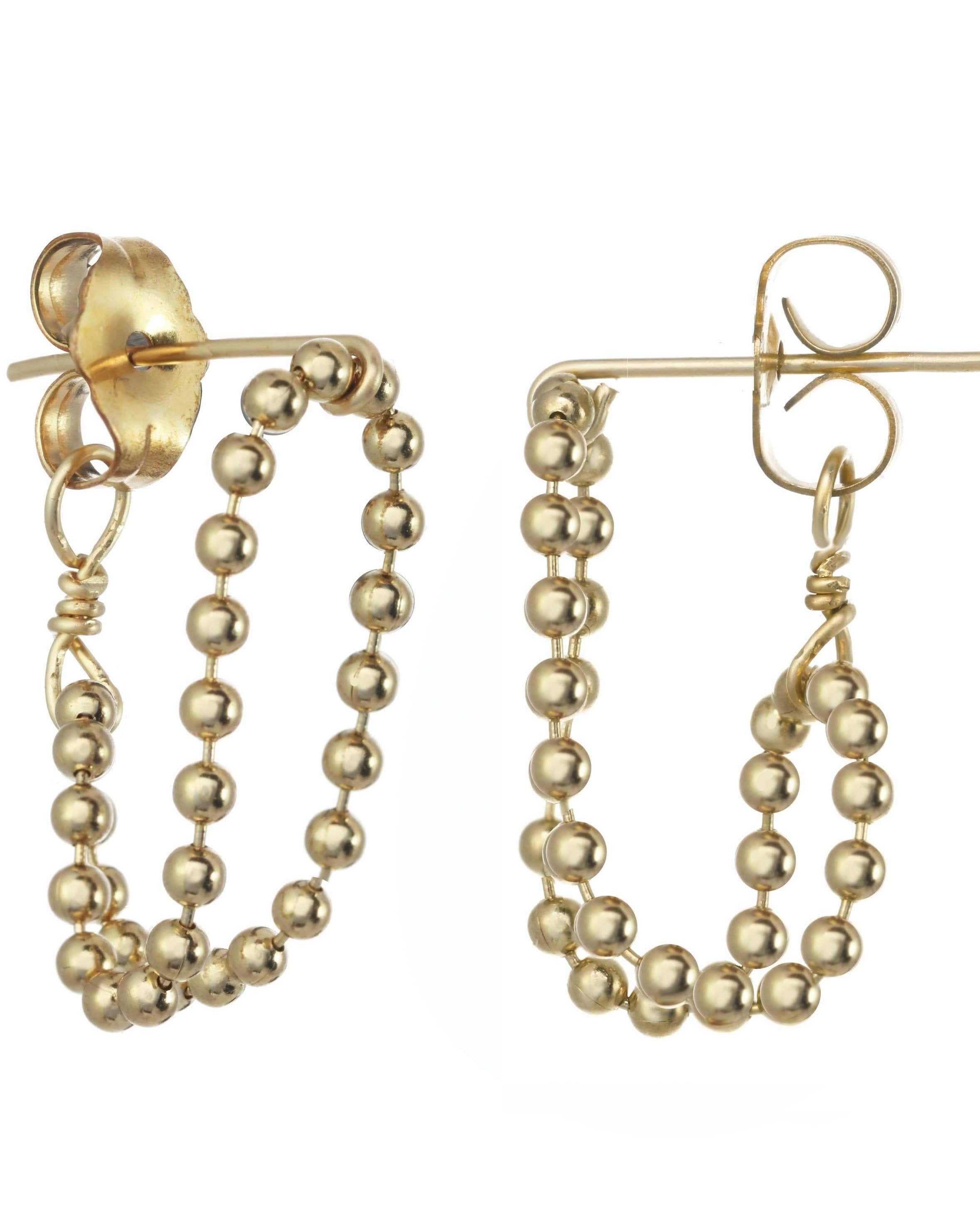 Venla Huggie Earrings by KOZAKH. Stud earrings, crafted in 14K Gold Filled, featuring a strand of 1mm seamless beads.
