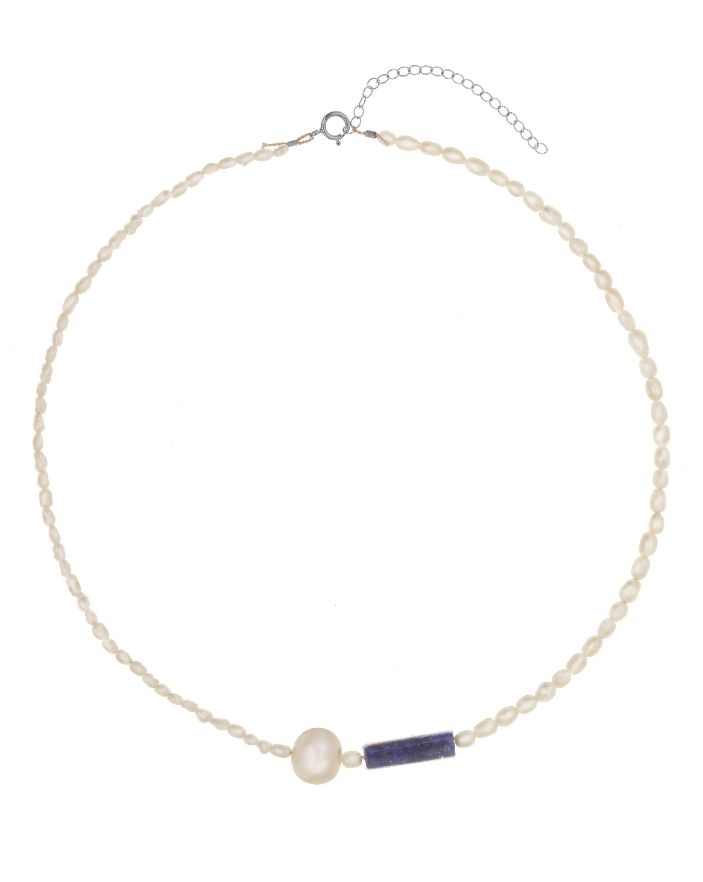 Wisdomkeeper Necklace by KOZAKH. A 15 to 17 inch adjustable length, freshwater rice pearl strand necklace, clasp crafted in Sterling Silver, featuring a round Freshwater Pearl and a cylindrical cut Lapis. 