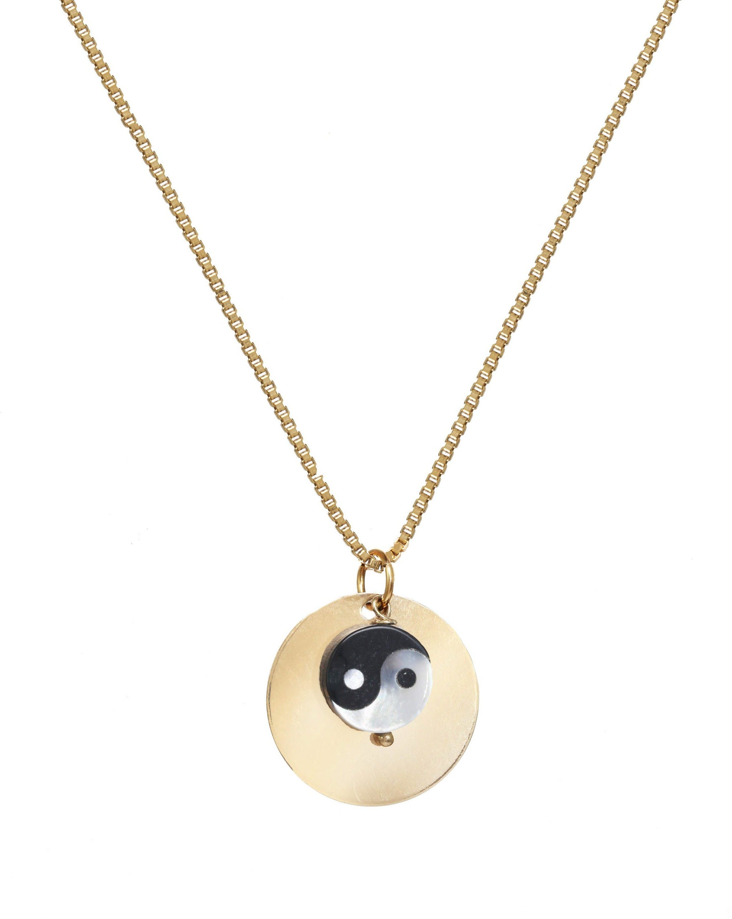Yin Yang Medallion Necklace by KOZAKH. A 16 to 18 inch adjustable length, box chain necklace, crafted in 14K Gold Filled, featuring a hand carved Mother of pearl Yin Yang charm and a 16mm medallion.