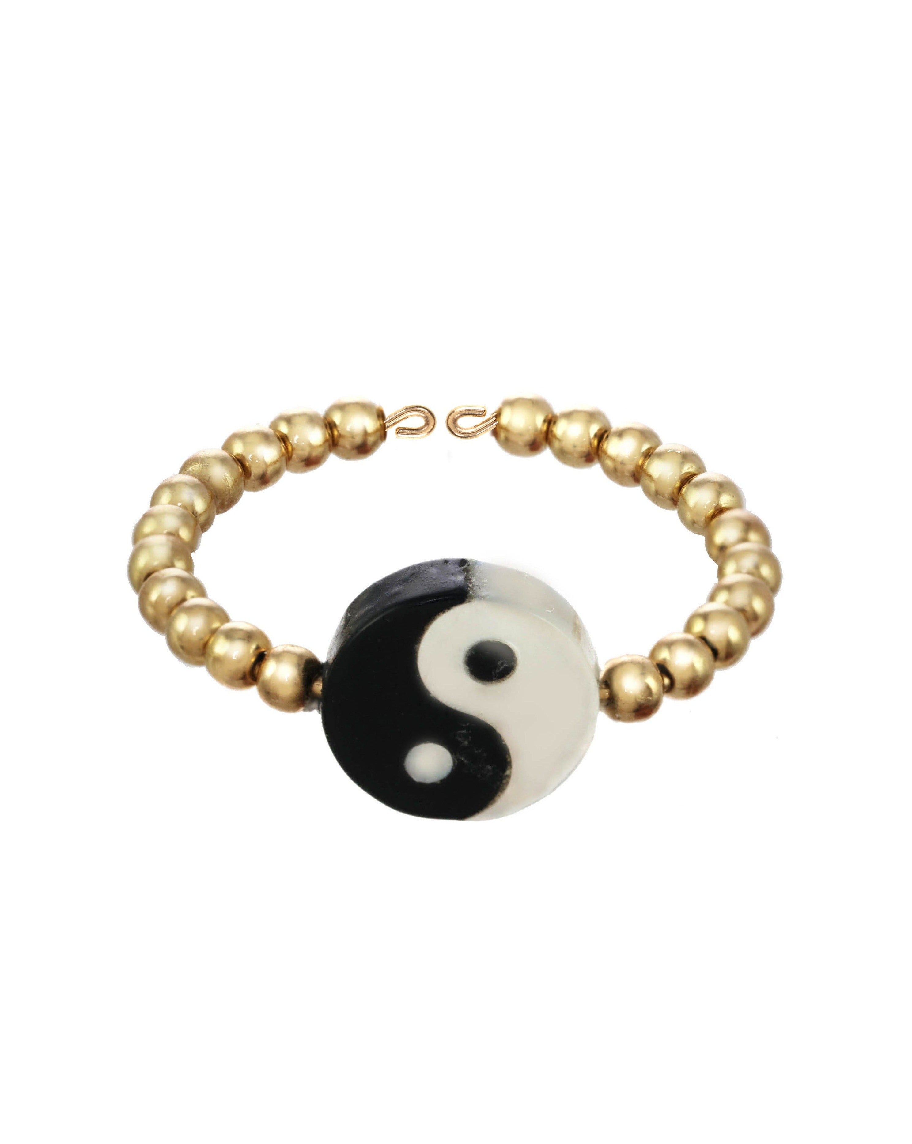 Yin Yang Ring by KOZAKH. A 2mm gold beaded band, crafted in 14K Gold Filled, featuring a hand carved Mother of pearl Yin Yang charm.