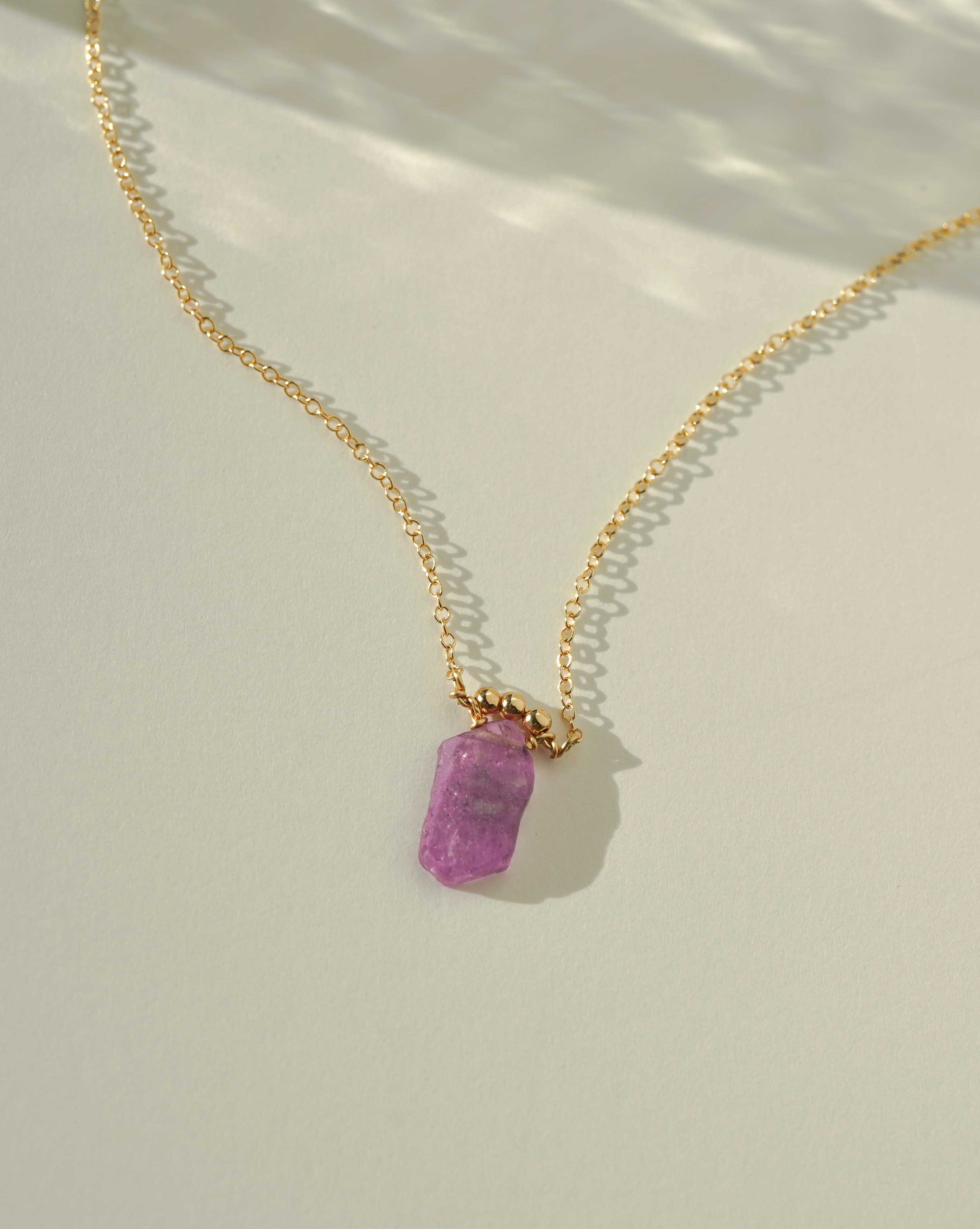 Zenda Necklace by KOZAKH. A 16 to 18 inch adjustable length necklace, crafted in 14K Gold Filled, featuring a Pink Tourmaline Slice and gold beaded accent.